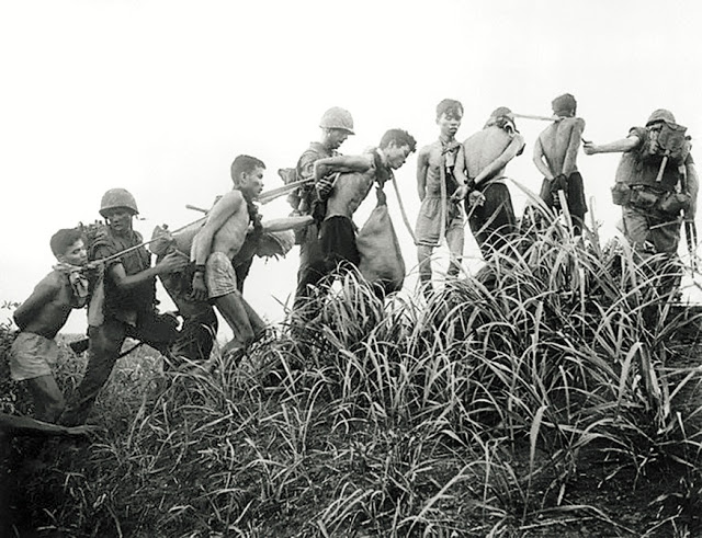 American soldiers and captured Vietcong guerrillas